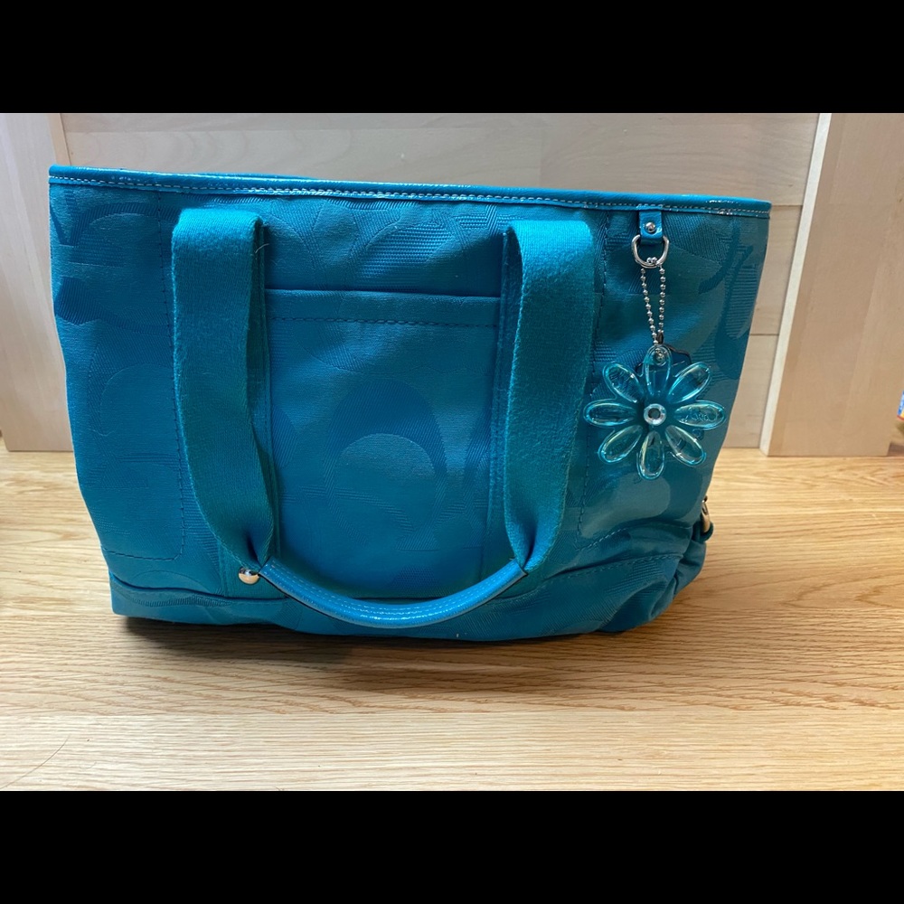 Teal coach tote used.